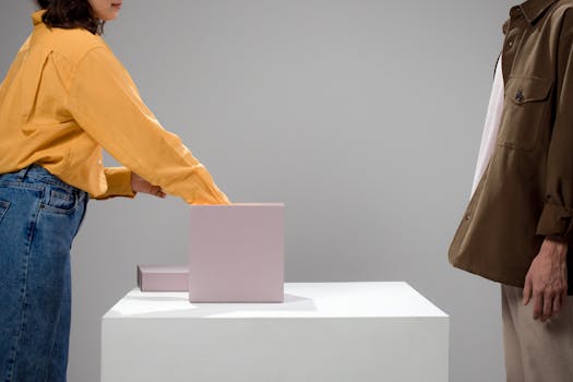 Conceptual minimalist scene of two unrecognizable people interacting over a box on a table.