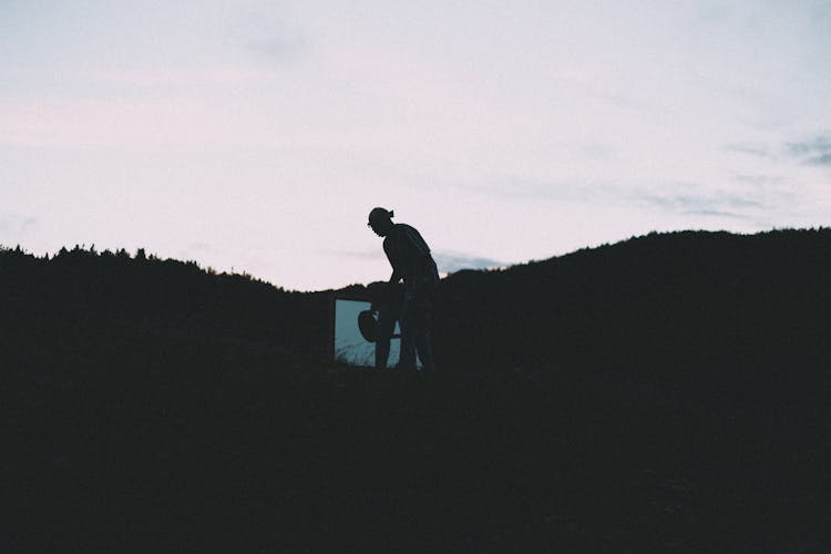 Person Standing With Frame On Hill