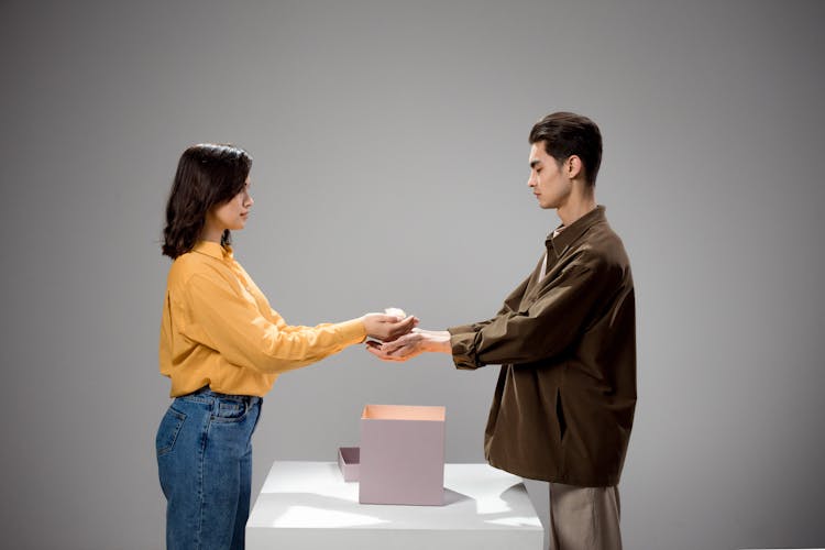 Woman Giving Gift To Man