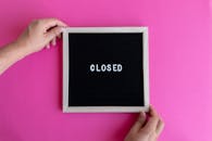 Hands Holding Blackboard with Text