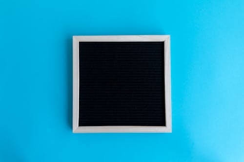 Free Empty Picture Frame on Blue Background Stock Photo