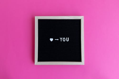Black Board with Loving Message on Pink Background