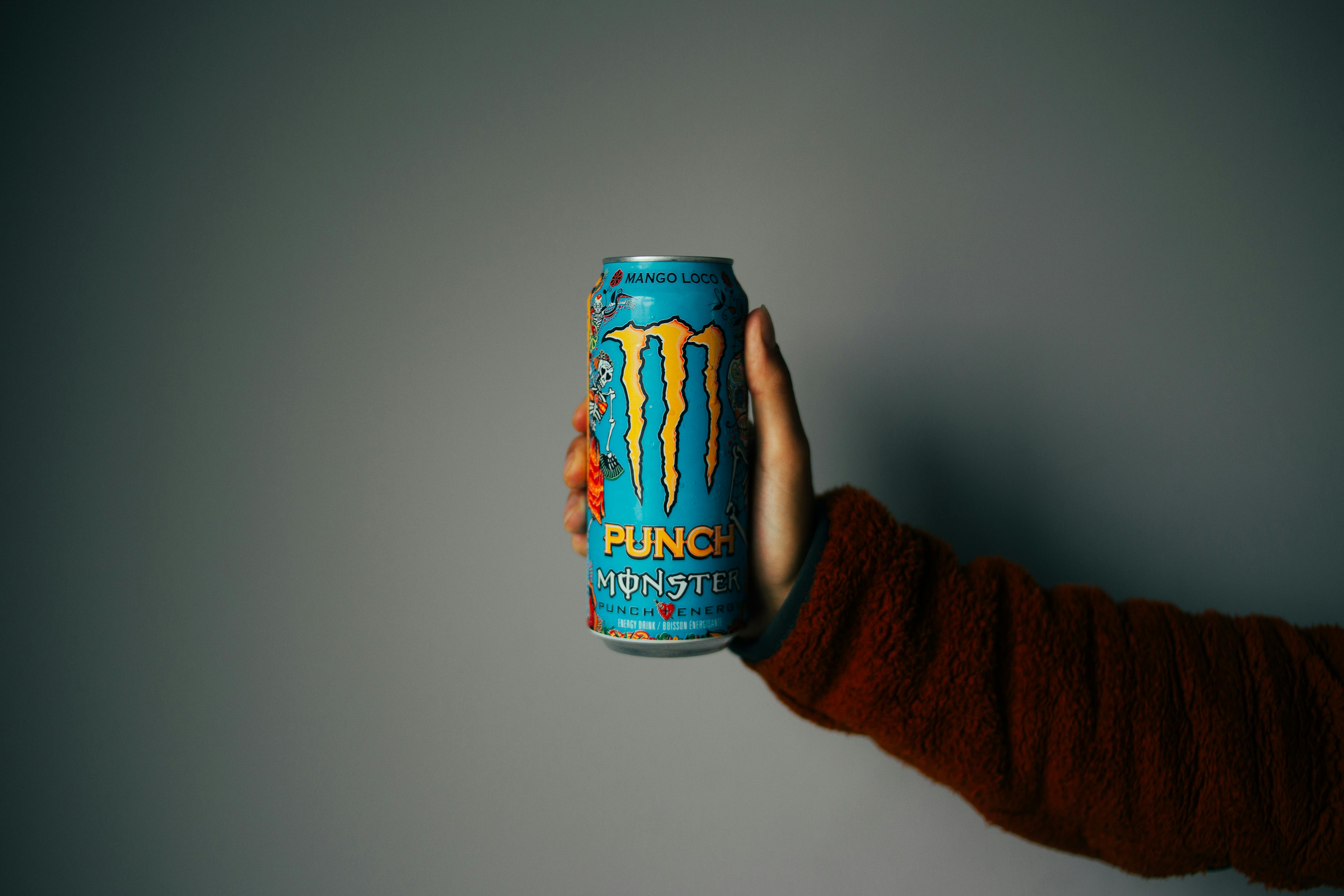person holding a can of energy drink