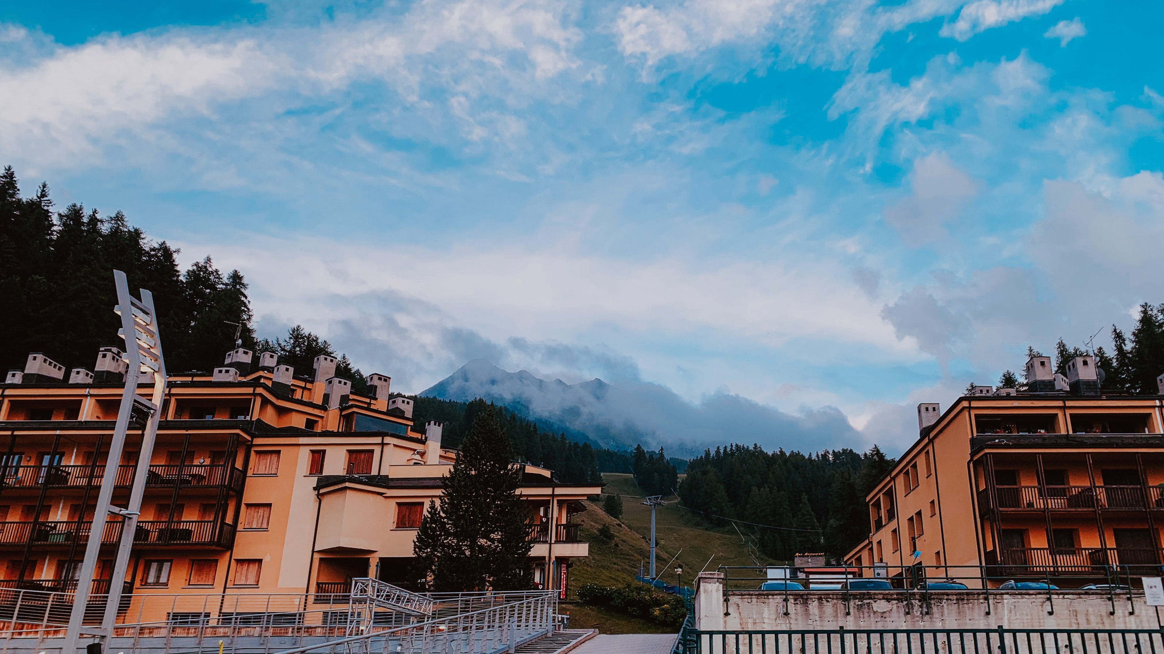 Hotel Buildings by a Mountain Range · Free Stock Photo