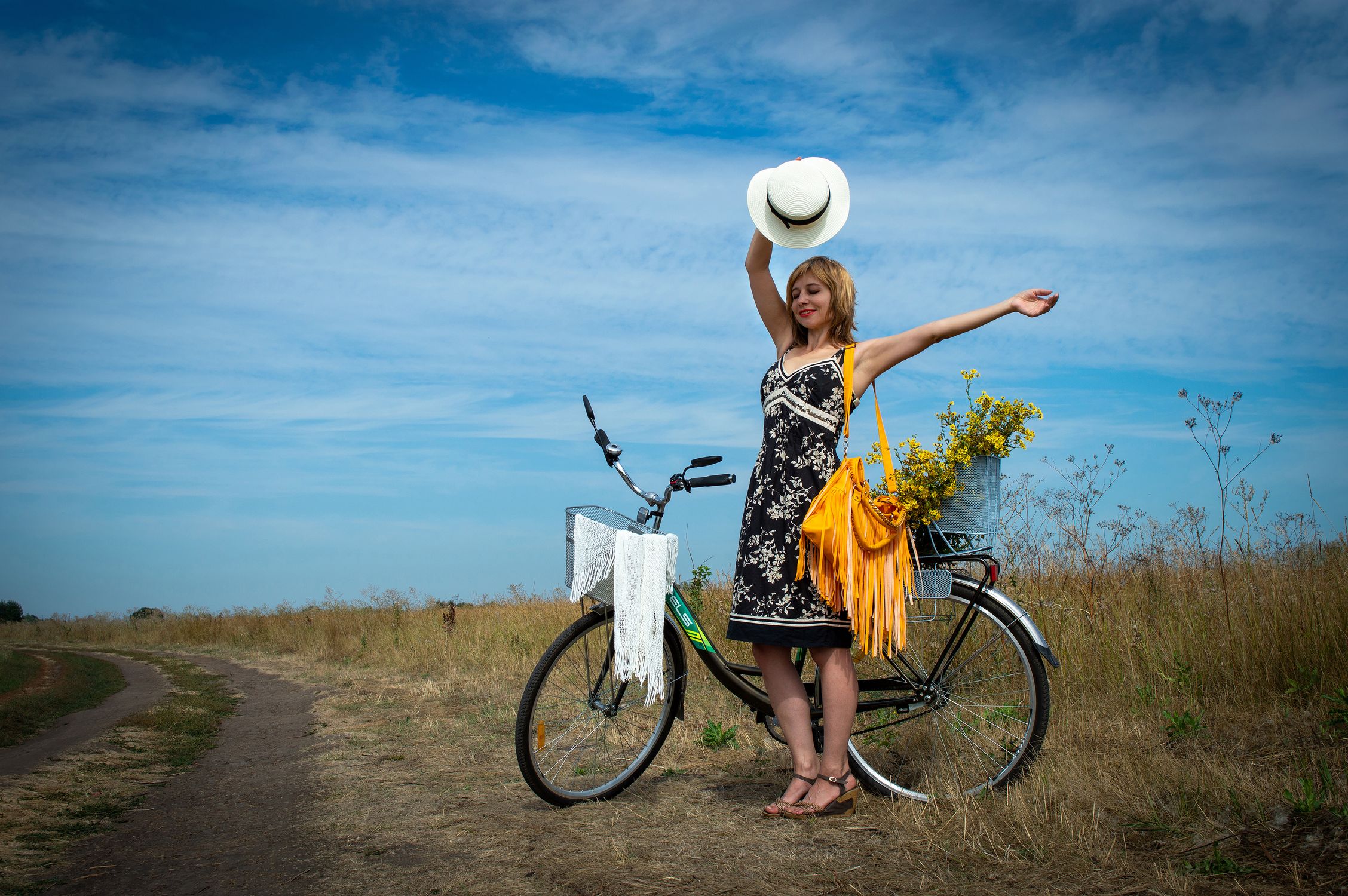 Woman in Black Dress Standing Beside a Bicycle · Free Stock Photo