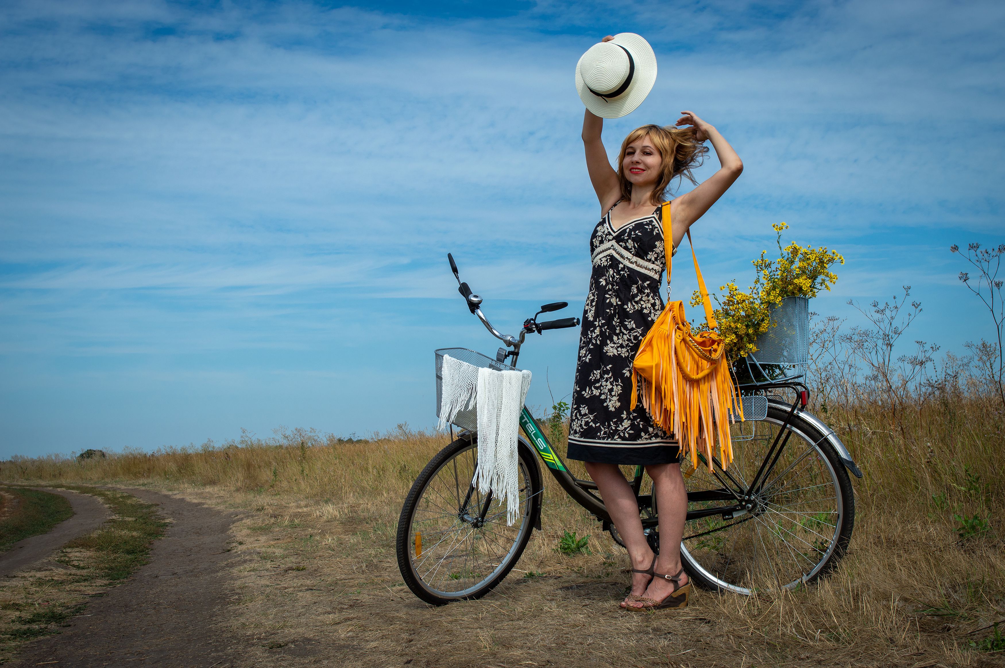 Woman in Black Dress Standing Beside a Bike · Free Stock Photo