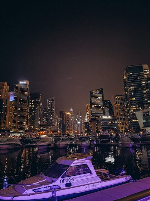 Motorboats Docked in Downtown Harbor at Night