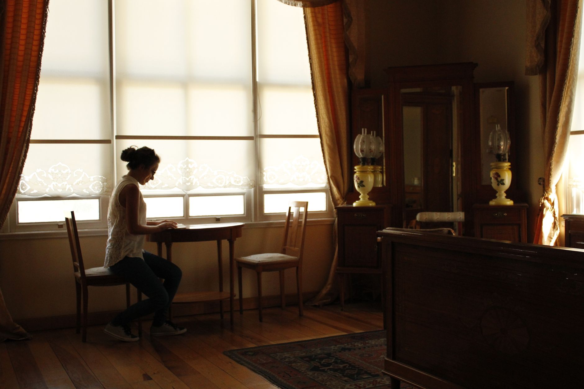 adhd lost sense of self adhd diagnosis adhd identity — woman sitting alone cozy room thoughtful warm lamp light