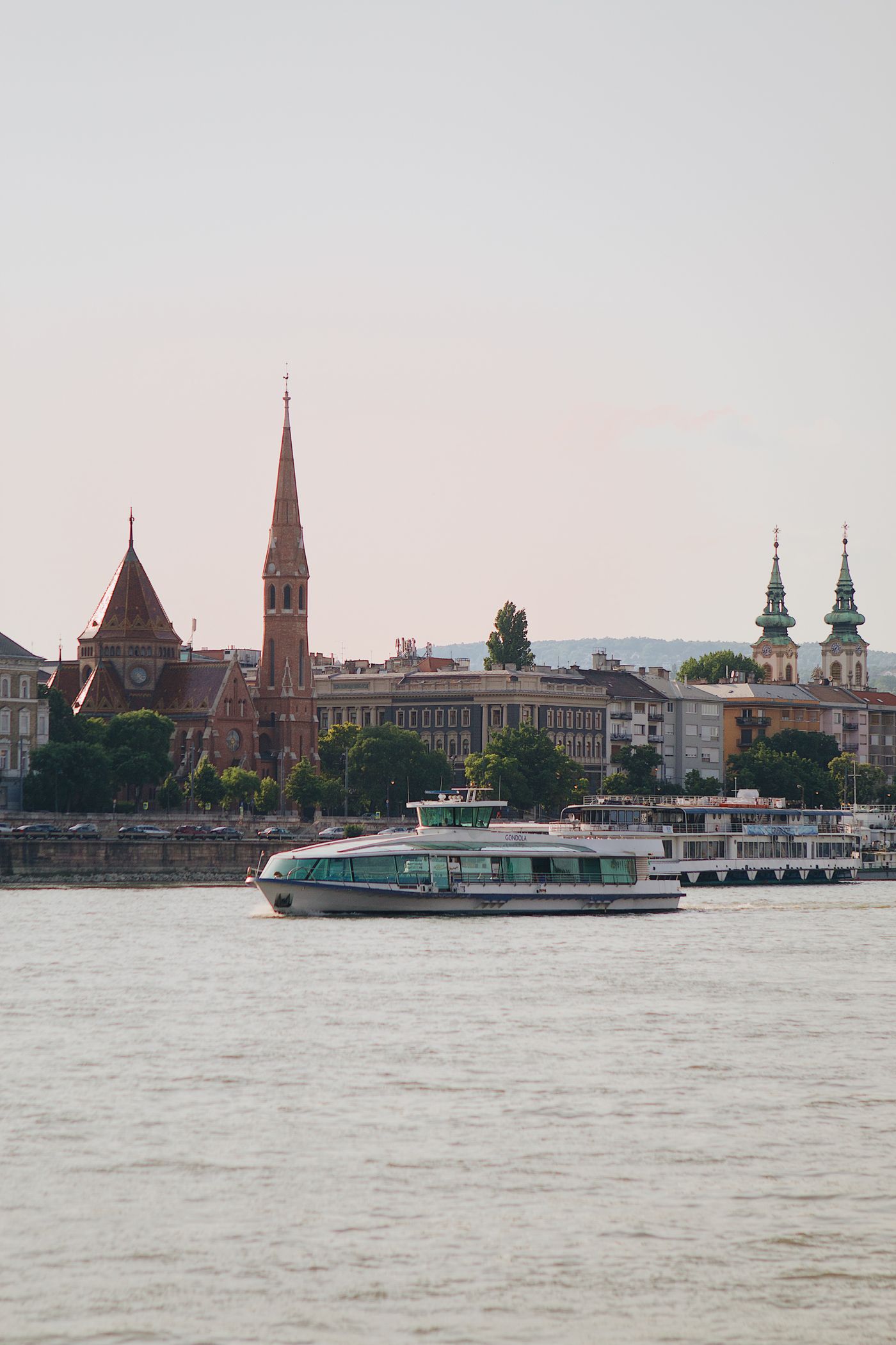 A river cruise ship moored on the Danube in Budapest with historic buildings behind