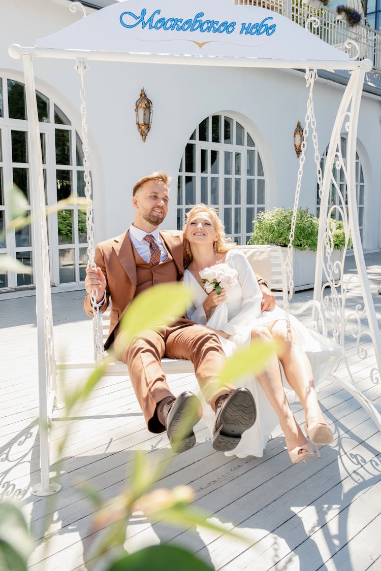 Married Couple On The White Porch Swing