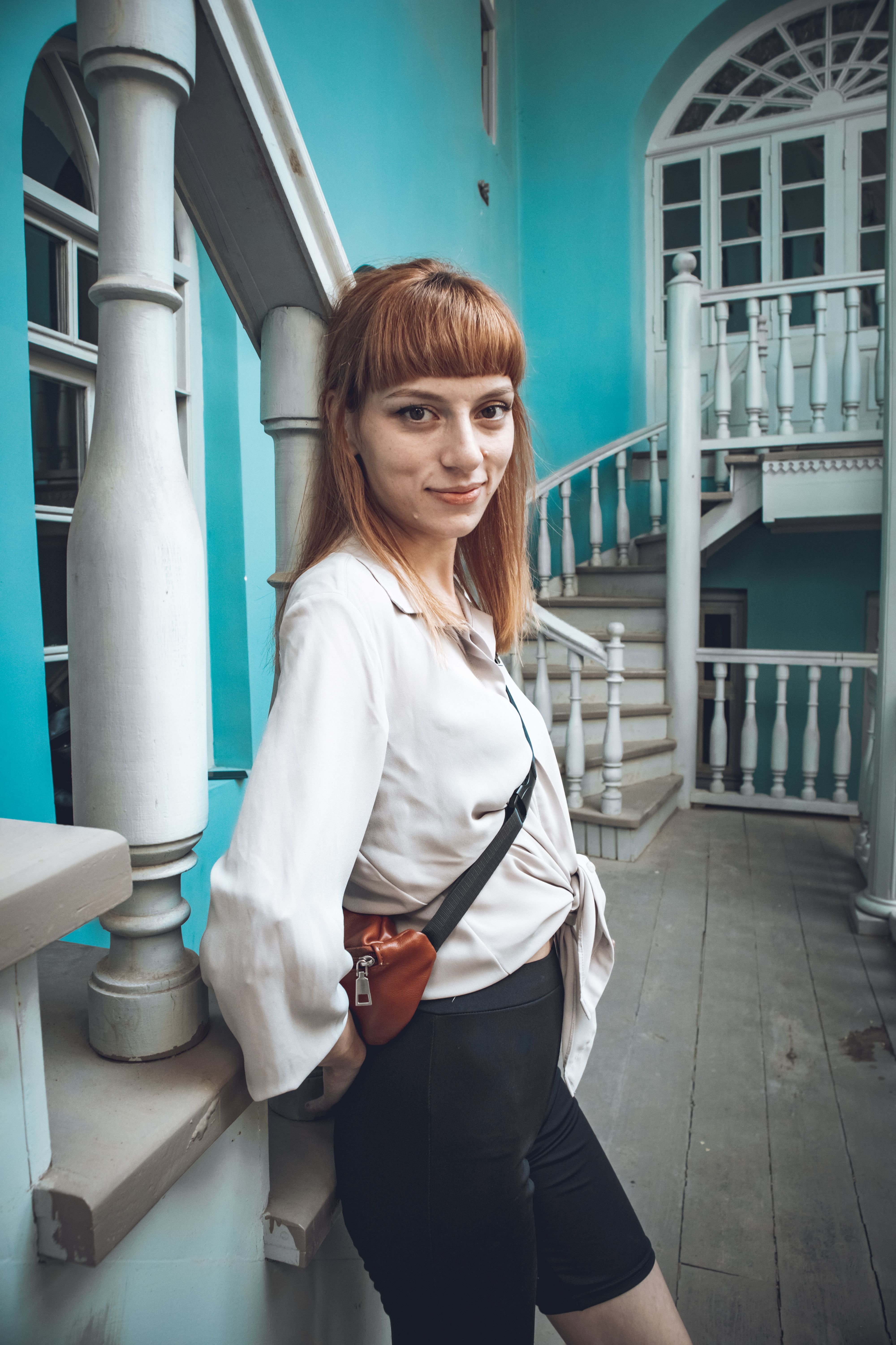 Woman in White Long Sleeve Shirt Standing Near the Stairs · Free Stock ...