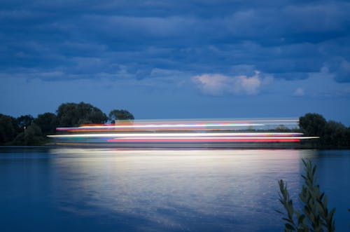 Motion Blur of Boat Sailing Across Lake