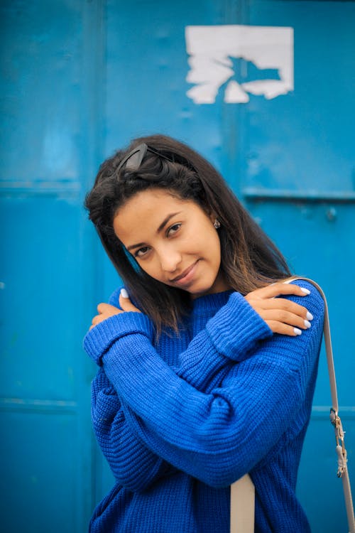 Woman in Blue Sweater Holding Her Hair
