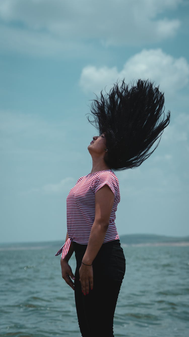 Woman Waving Hair On Sea Background