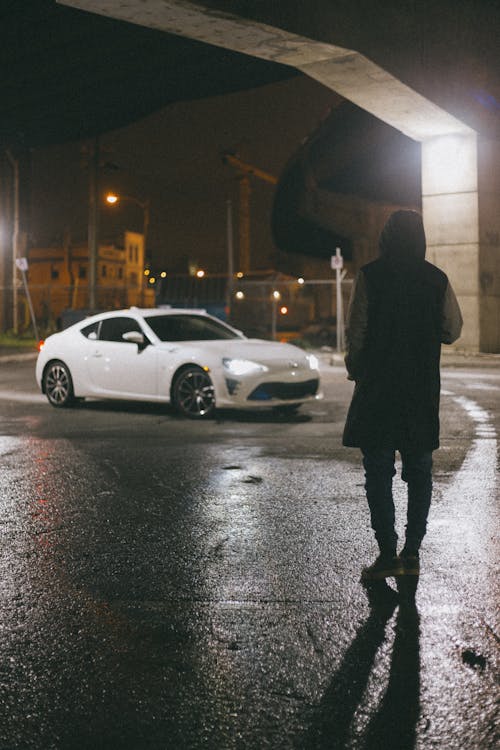 A White Car and a Person on a Street