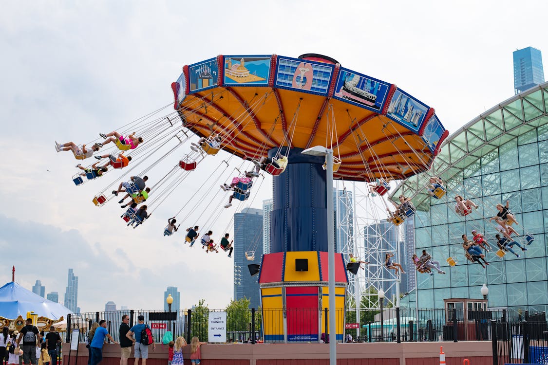People Riding in Swing Carousel · Free Stock Photo