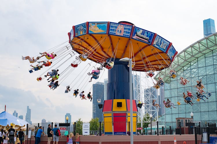 People Riding In Swing Carousel