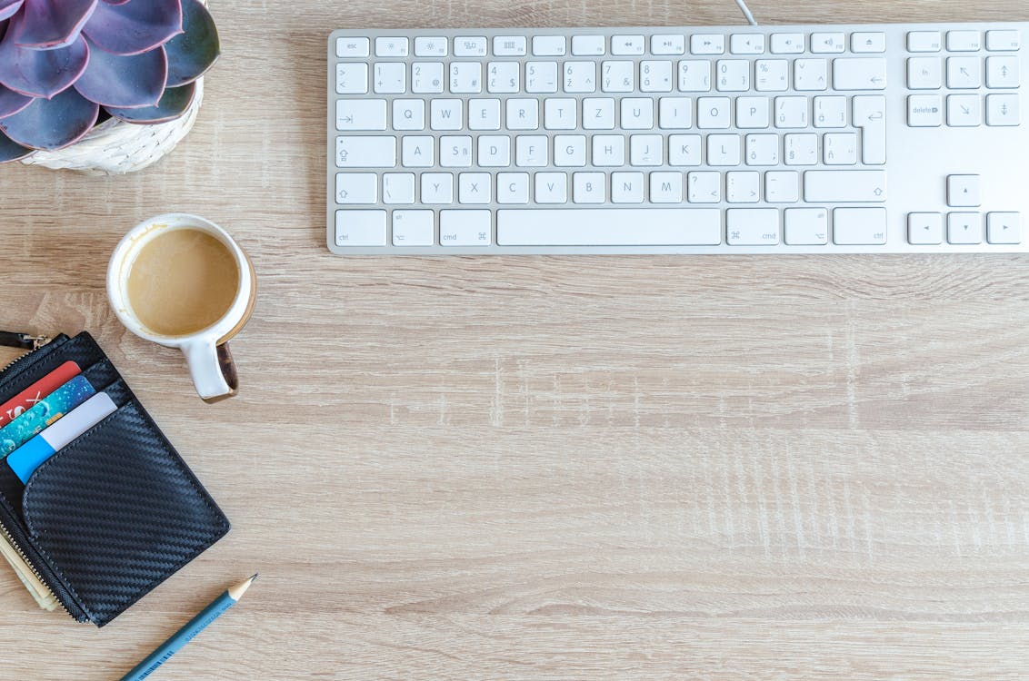 White Apple Keyboard Near White Cup