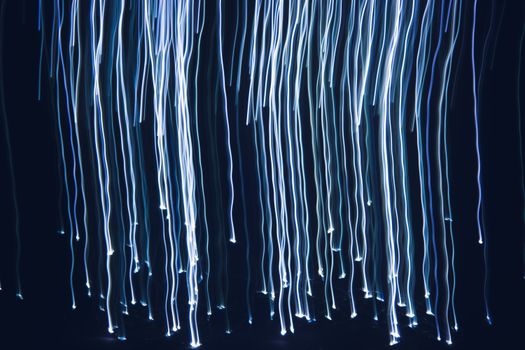 Abstract image of blue light streaks creating a dynamic and modern pattern, ideal for backgrounds or wallpapers.
