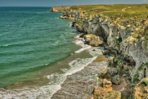 Waves Crashing on the Shore Near the Cliff