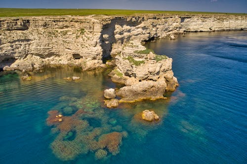 Gray Rock Formation on Blue Sea Water