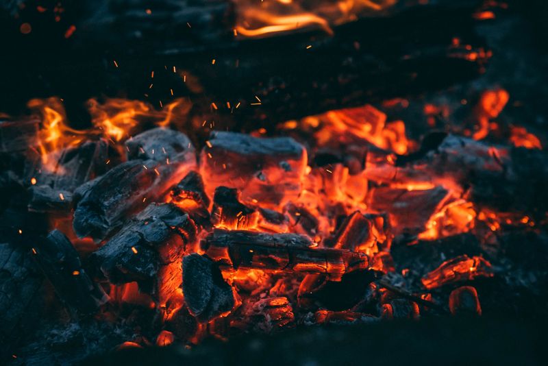 Close-up of glowing embers and burning charcoal — photo by Limonovich on Pexels