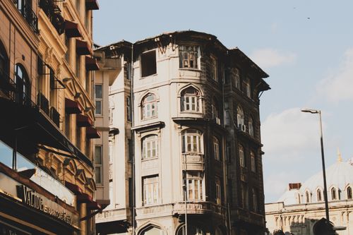 Free Low-angle view of old urban buildings with classic architecture and clear sky background. Stock Photo