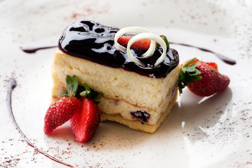 Free A Sliced Cake With Strawberries on a Ceramic Plate Stock Photo