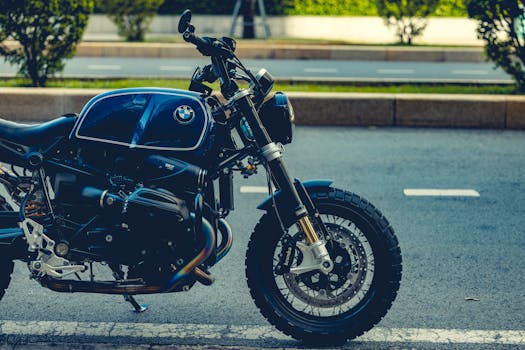 Stylish BMW motorcycle parked on city roadside reflecting urban elegance.