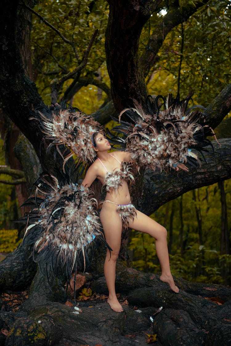 A Woman In National Costume Posing Near A Big Tree