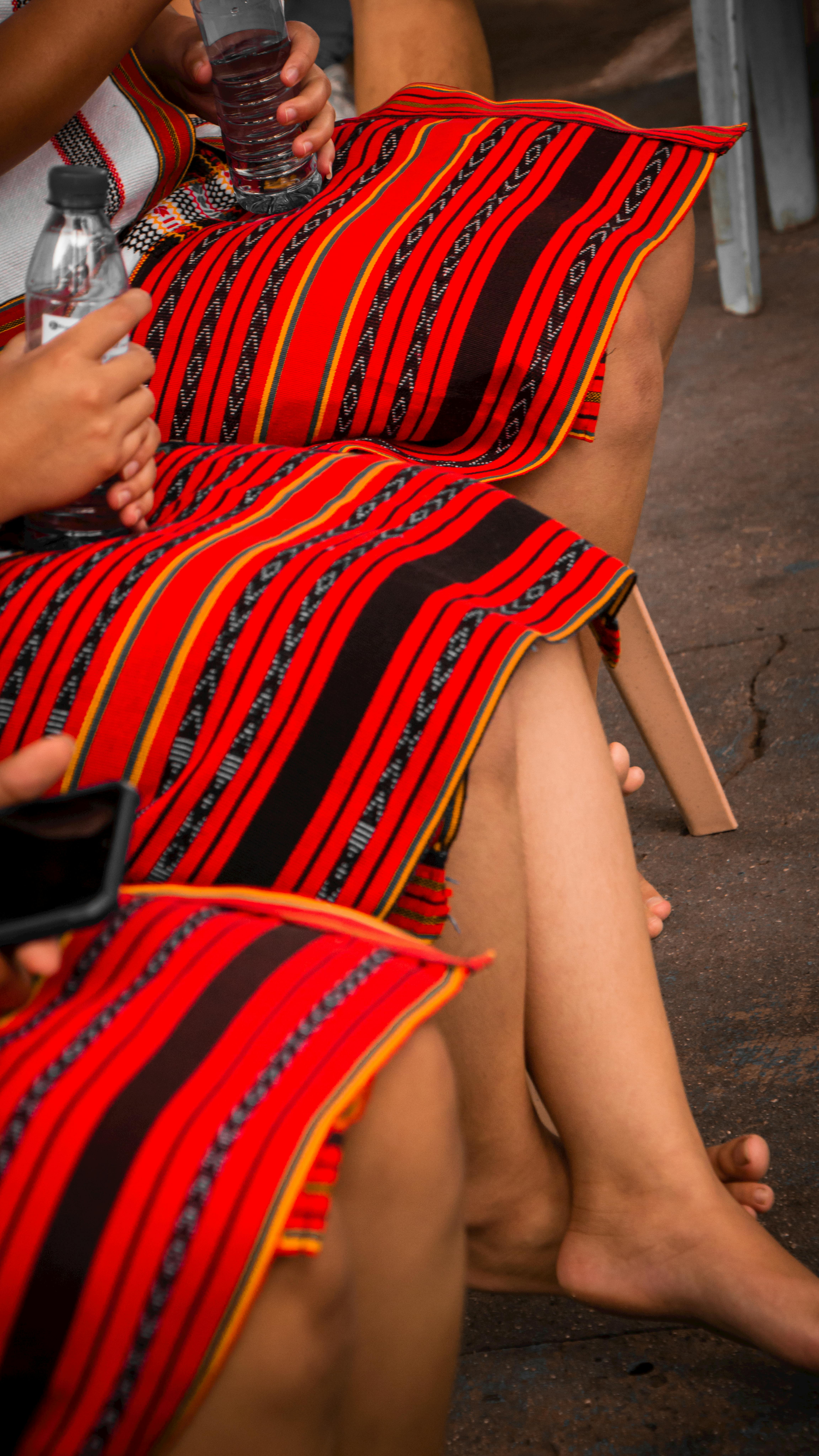 Close-up of vibrant traditional garments, focusing on colorful patterns and cultural design.