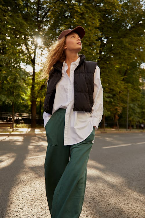 A Woman Standing on the Street with Her Hands in Pockets