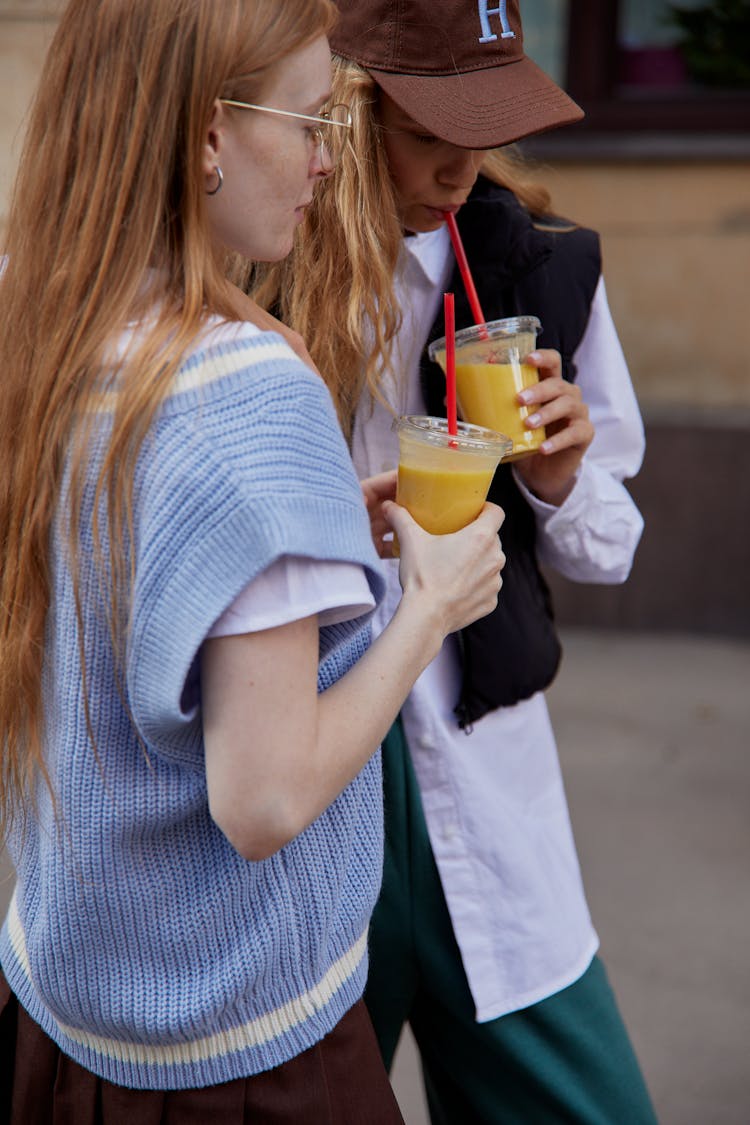 Women Holding Smoothies In Plastic Cup