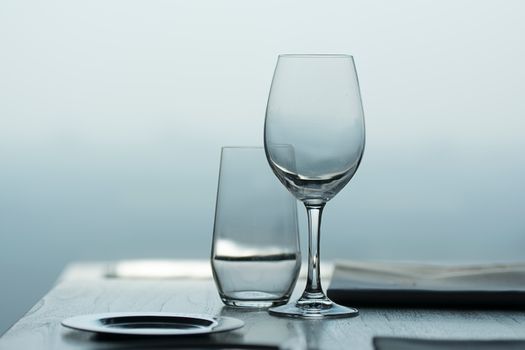 Close-up of a wine and water glass on a table with soft focus background.