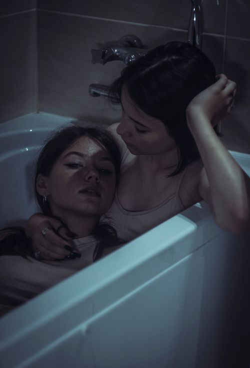 Free Two women sharing a tender moment in a bathtub, highlighting intimacy and love. Stock Photo