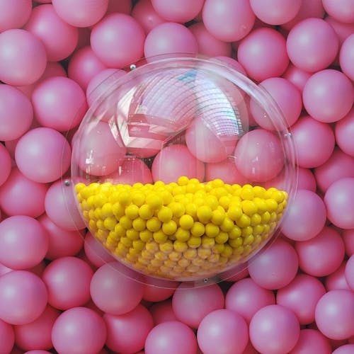 Yellow Balls on Clear Plastic Container