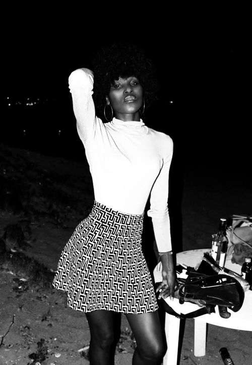 Free Black and white image of an African woman posing boldly with a fashionable style. Stock Photo