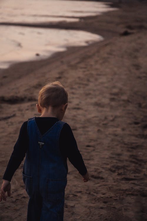 Back View of a Boy Walking at the Beach