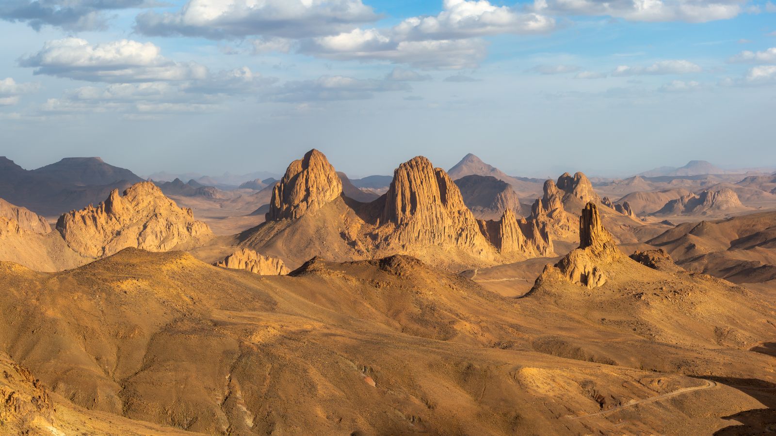 Brown rock formations under white clouds, Chad