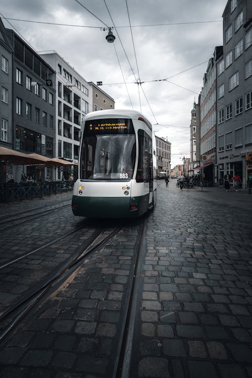 Free Tram Travelling Near the Buildings Stock Photo