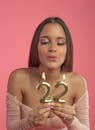 Woman Blowing Number Candles