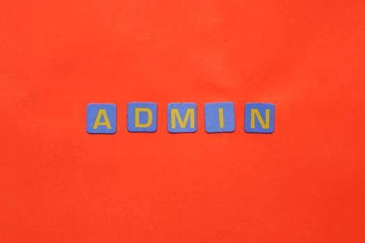 Vibrant display of 'ADMIN' text on a bright red surface.