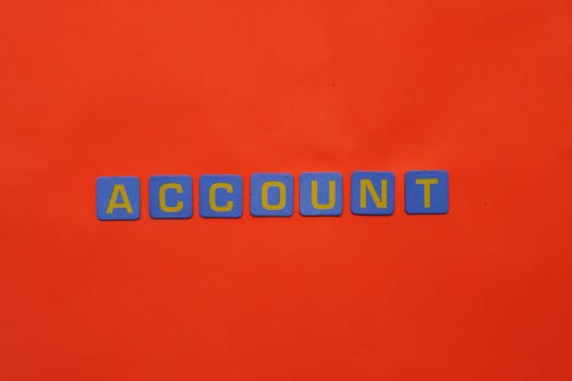 Blue letters spelling ACCOUNT on a vibrant red background, ideal for design and marketing.