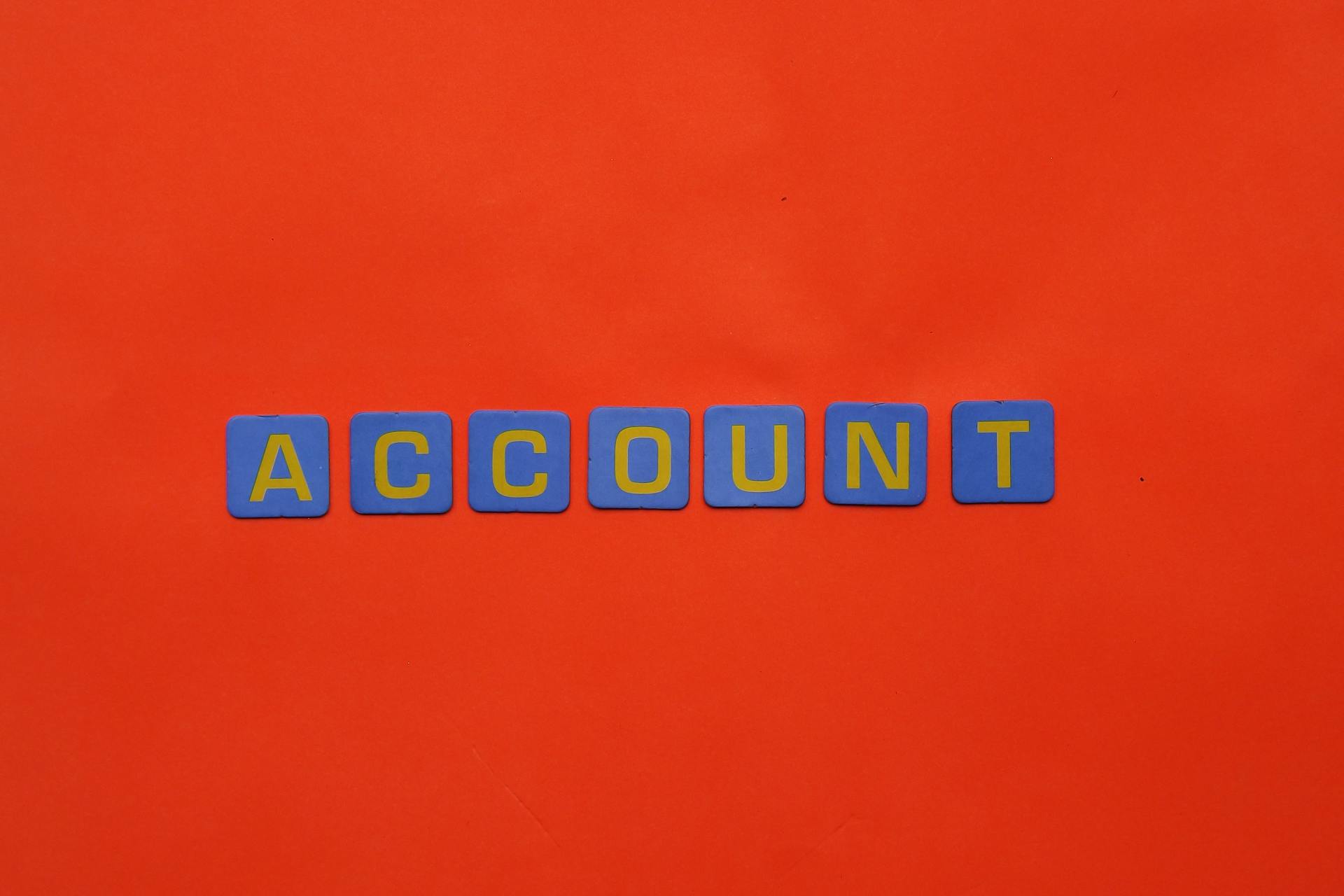 Blue letters spelling ACCOUNT on a vibrant red background, ideal for design and marketing.