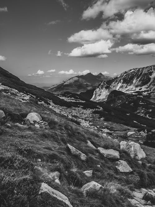 Grayscale Photo of Mountains and Clouds