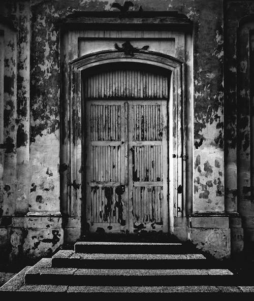 Grayscale Photo of a Front Door with Steps