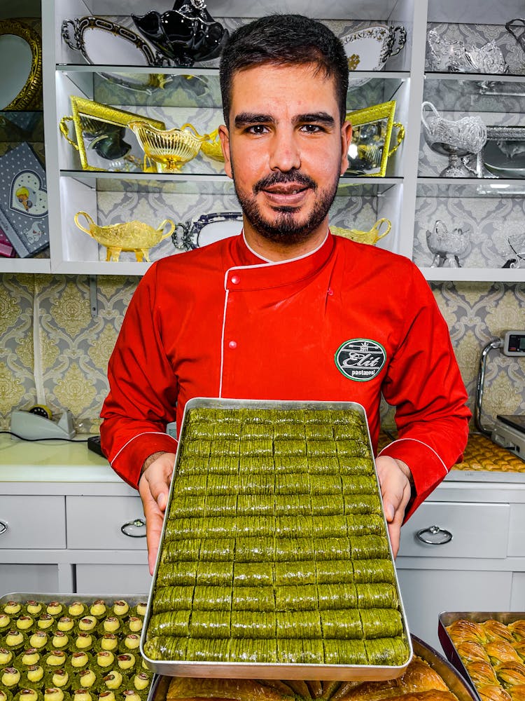 A Man Holding A Stainless Tray With Food