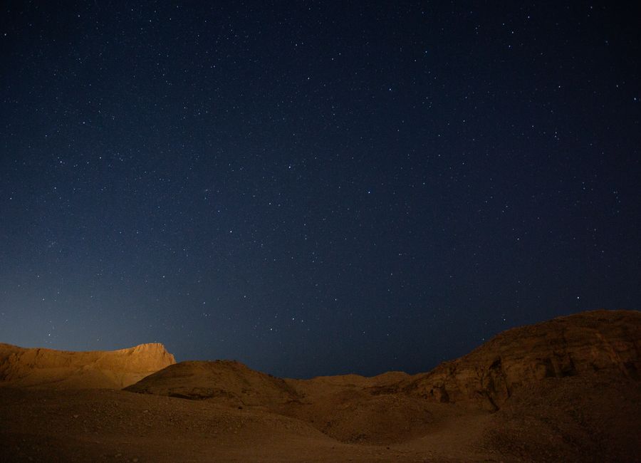 A stunning view of the starry night sky above the desert hills in Esna, Egypt.