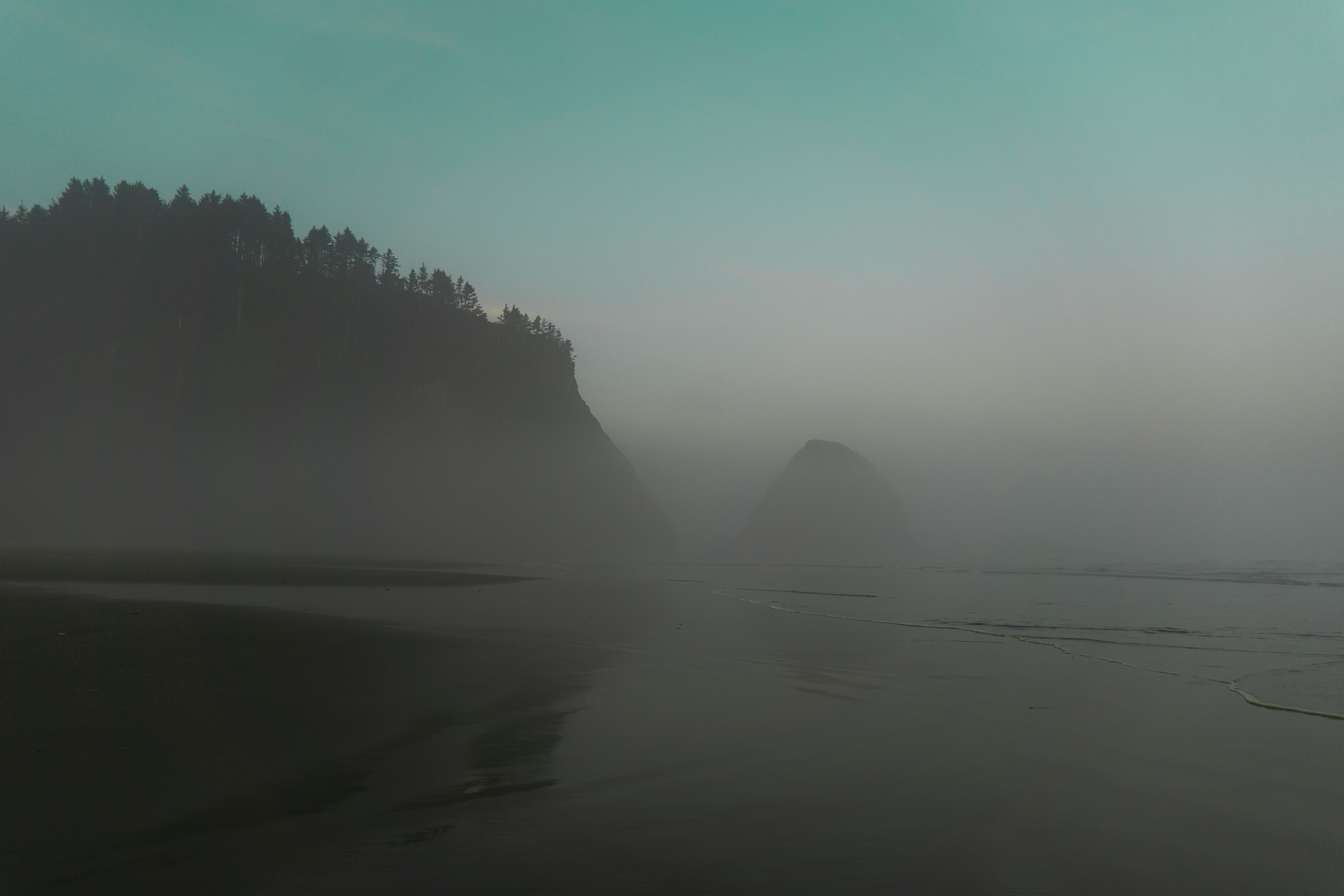 Silhouette of Mountain Near Body of Water · Free Stock Photo