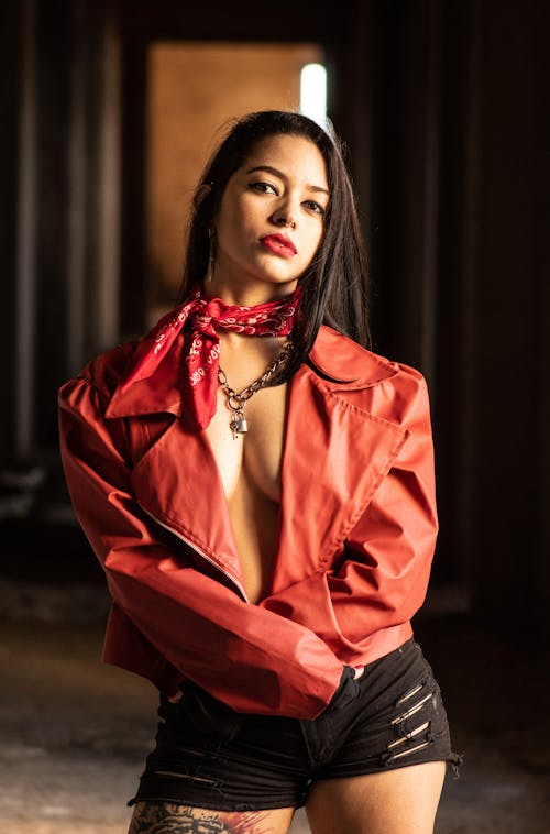 A Sexy Woman on Red Leather Jacket with Scarf on Her Neck